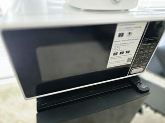 Black and white microwave with digital controls