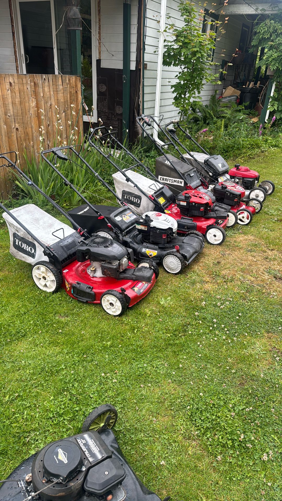 Four self-propelled lawnmowers, and one Honda