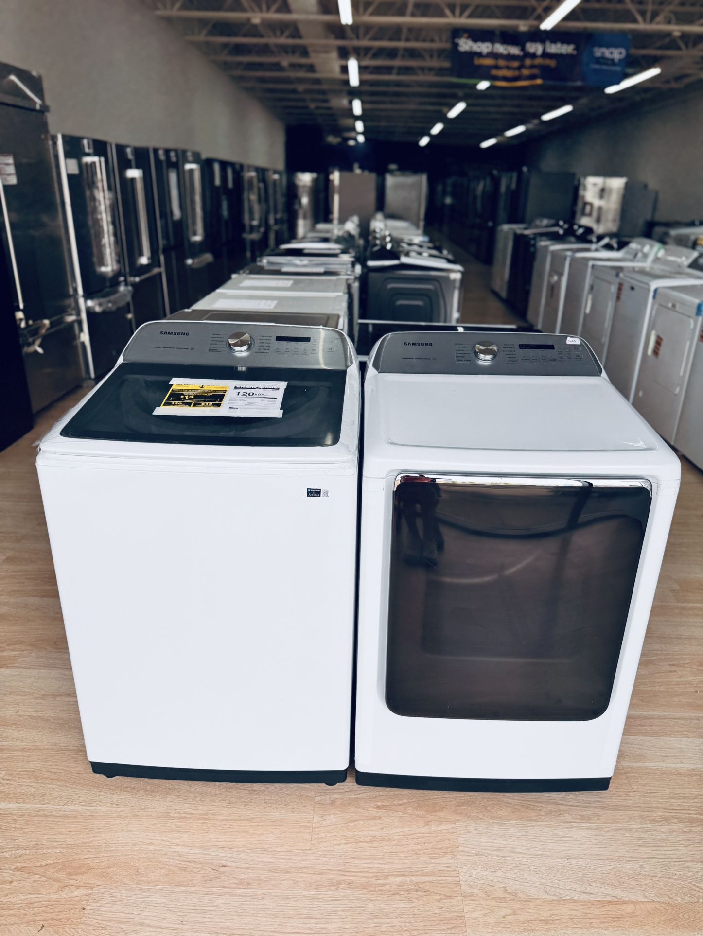 New Samsung 5.1 cu. ft. Smart Top Load Washer with ActiveWave Agitator and matching 7.4 cu. ft. Gas Dryer with Steam Sanitize+ in white.
