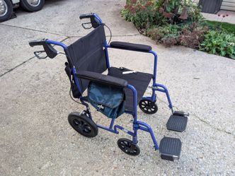 Medline Lightweight Foldable Transport Wheelchair with Handbrakes and 12-Inch Wheels, Blue.