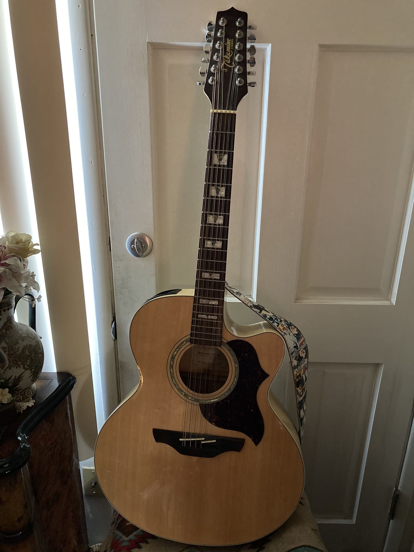 Takamine 12-String Acoustic /Electric Cutaway -Jumbo Guitar ; Model -EG 523 SC-12. It’s a G-Series , w/ Creamy/White Maplewood . Natural Spruce -