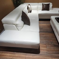 White Leather Sectional with some cracks. 