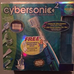 New in box cybersonic 2 electric toothbrush set