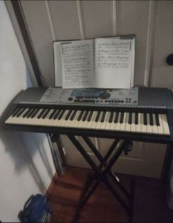 Professional studio Yamaha keyboard with stand and book. All work with no issues will not separate.