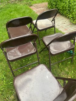 Five folding metal chairs