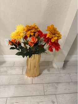 Flowers in large vase with filling.