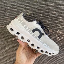 On Cloudmonster running shoes. 