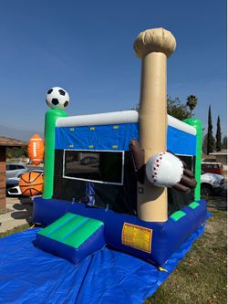 Sports theme bounce house jumper with basketball hoop