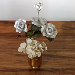 Lovely Floral Arrangement: Silver & White Flowers, Gold foiled Glass Vase. Overall Size: 18” x 10”.