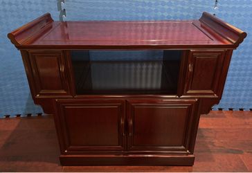 Rosewood solid with rollers at the bottom cabinet. 40inches x 20inches