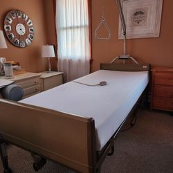 Adjustable electric bed, trapeze, twin XL mattress, cover & side rails. Remote adjusts head, legs & height. 