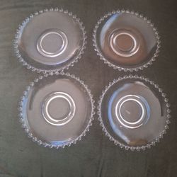 Four Candlewick saucers