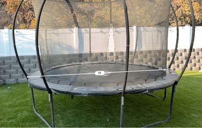 10-foot Jumpzylla trampoline with black safety mesh enclosure net.