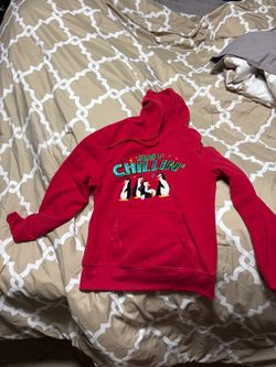 Comfortable red hoodie with playful "Just Chillin'" penguin graphic.