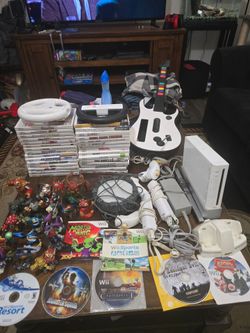 Wii bundle 37 games, 17 skylander figurines-portal-skylanders giants game,controllers,console,remote charger and 2 steering wheels.