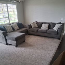 Comfortable Gray L-Shape Sectional Couch with Patterned Pillows