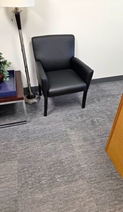 Black faux leather armchair