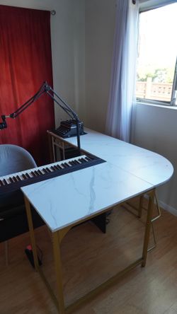White l-shaped desk with gold legs