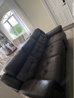 Electric reclinable couch in brown leather