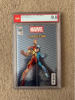 KITH MARVEL VS. CAPCOM #1 IRON MAN VS. MEGA MAN BLUE VARIENT IN HAND 9.8 PSA