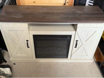 Fireplace tv stand has heater control on it also