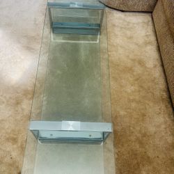   Tiffany Two Tear Glass and Chrome Coffee Table  Dimensions: H12x W18x L63  The table top and second tear is strong tempered clear 1/2 inch glass whi