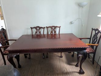 Hand carved dining room table and chairs with 2 captains chairs