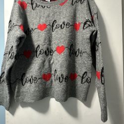Cupcakes and Cashmere long-sleeve crewneck sweater, often referred to as their "Fuzzy Love and Hearts" sweater. It features a grey knitted base adorne