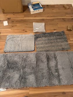 One New IKea carpet in plastic  3x5  / two bath mats / one 5 foot x 2 foot hall carpet