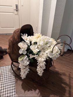 vintage baby stroller with artificial white flowers $150