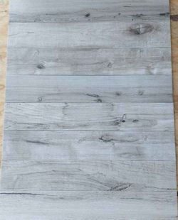 904 square feet 6X36 Wood Plank LOOKING porcelain tile. Silver/Bianco in color.