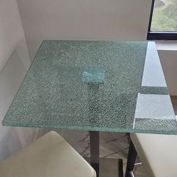 High top shattered glass table with 2 stools.