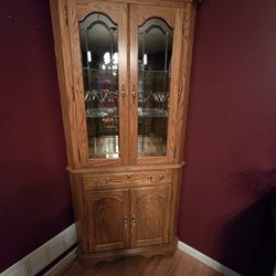 Corner unit decorative Amish wood curio cabinet.