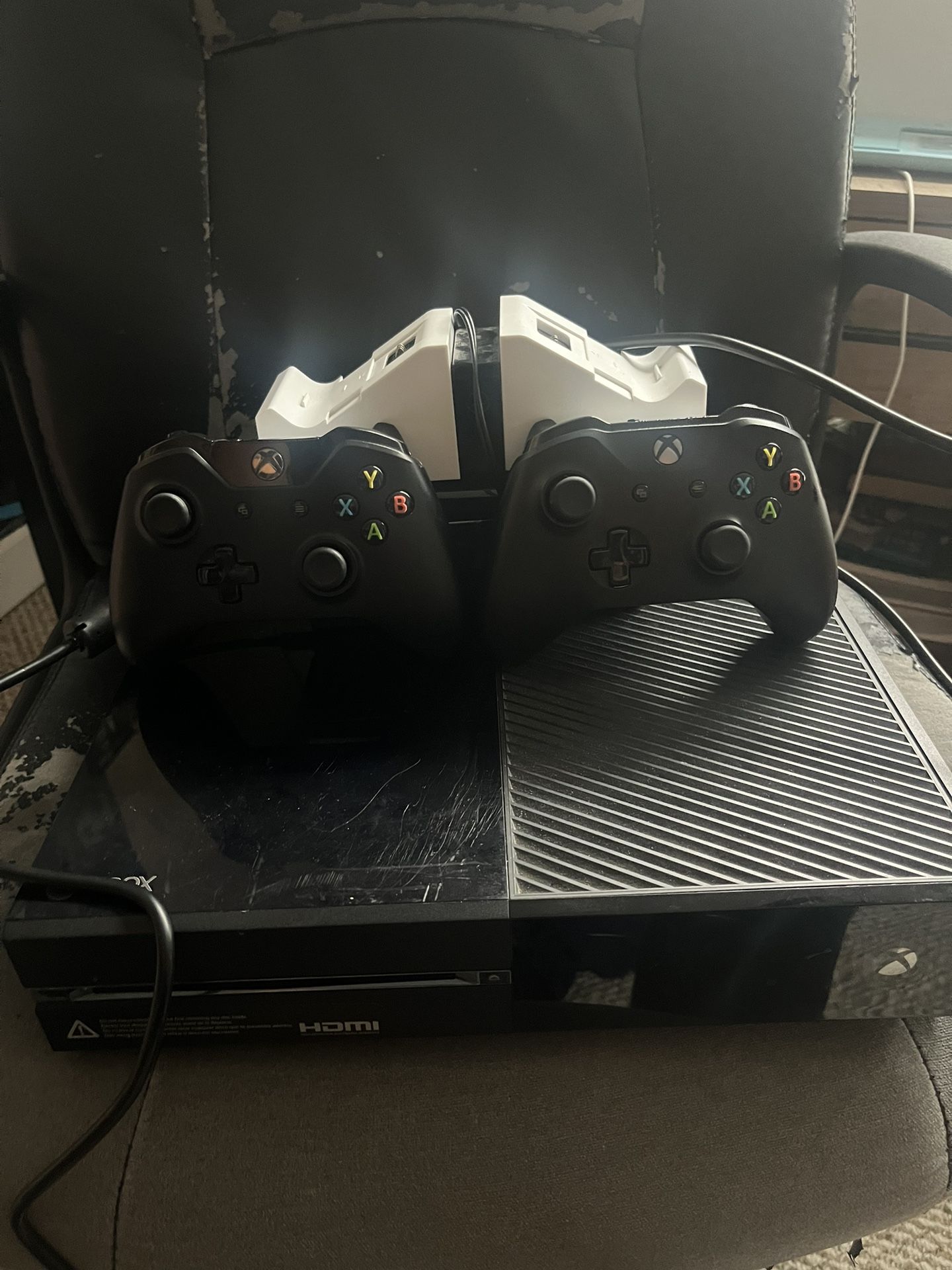 Xbox One , two controllers, wireless charging station, hdmi box and cable