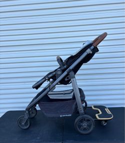 UPPAbaby Cruz stroller equipped with a matching UPPAbaby PiggyBack ride-along board