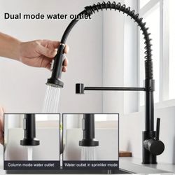 A Dual Spout Nozzle Faucet With A Spring Pull-down Sprayer For Hot And Cold Water, Mounted On The Deck.