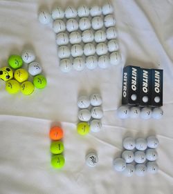 66 golf balls. Mostly new.