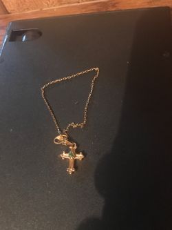 Woman’s gold cross bracelet
