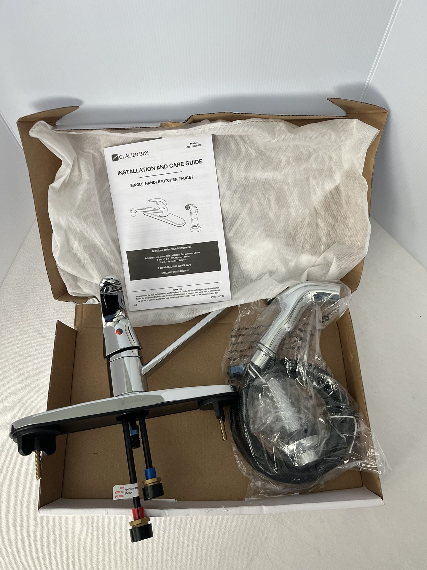 Glacier Bay single-handle kitchen faucet with a side sprayer in chrome. 