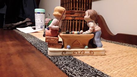 Boy and girl playing pool figurines