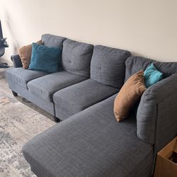 L-shaped couch (w/ brown pillows Included) - Blue-gray Color. like new barely used