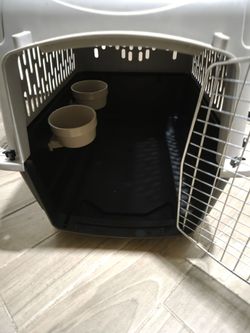 Dog crate with feeding bowls