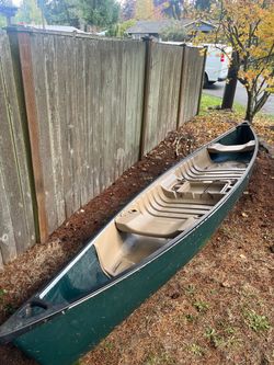 Green Canoe with Seats and Paddles