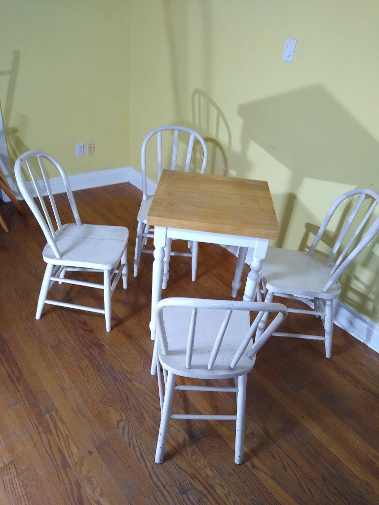 Wooden butcher block top kitchen table with four wooden chairs