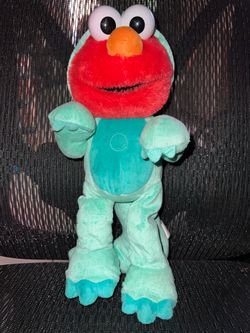 Sesame Street Dino Stomp Elmo 13-Inch Plush Stuffed Animal Sings and Dances.
