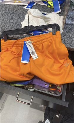 orange woman’s adidas shorts 