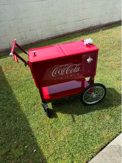 The red rolling ice chest NEW… is a leigth country.. Coca- Cola enbossed. Ice cold cooler. featurin a retro metal the same with a lower storage shelf 