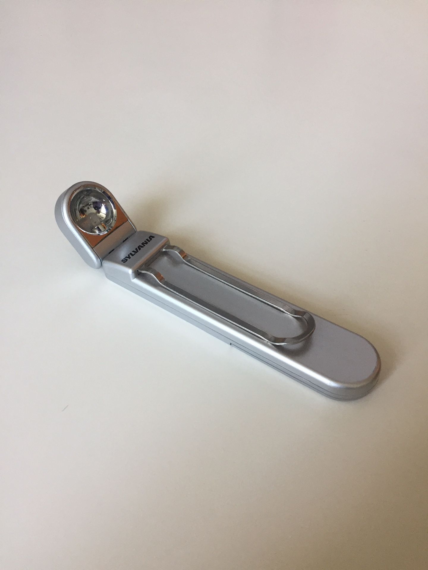 Elegant Small Folding Flash Light with clip. Very convenient. Lets you reach with light unreachable areas.
