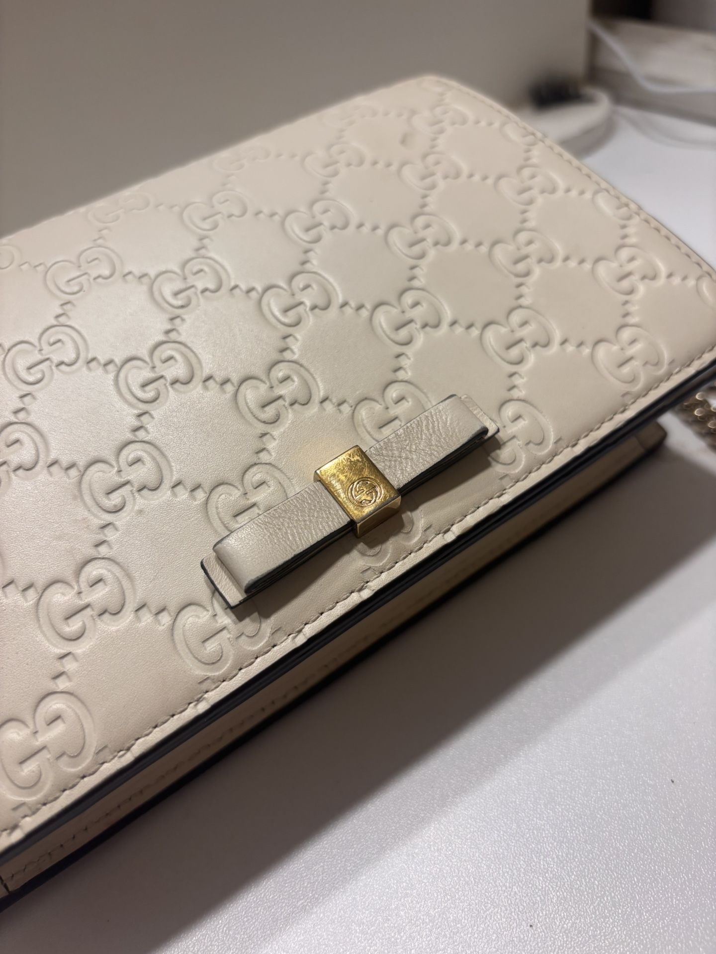 Gucci Beige Embossed Leather Clutch With Gold Bow