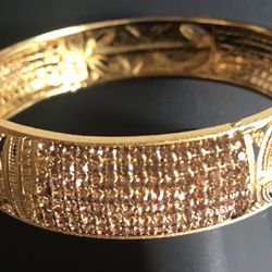 Gold color shiny bangle bracelet with rhinestones